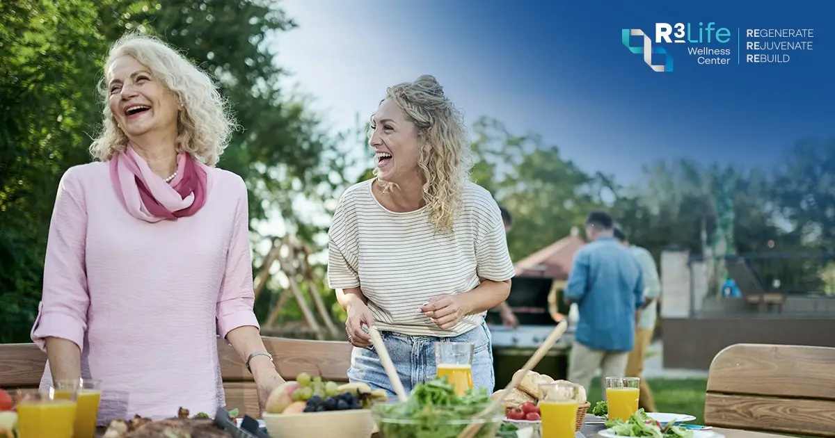 Women sharing a meal and laughing together, reflecting food, social connection, and the Blue Zones lifestyle